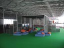 Você gostaria de participar de uma experiência artística?; 1994-2007, 20 objetos de aço pintado em circulação pela América Latina, África e Europa; documentação produzida pelos participantes disponível em www.nbp.pro.br; objeto 125 x 80 x 18 cm, estrutura de ferro pintado, grades de ferro, objeto de aço pintado, tapete, colchonetes, almofadas, 8 monitores, 2 DVDs, 4 computadores, 8 câmeras de circuito-fechado, 2 sistemas de circuito-fechado, diagrama, painel com texto; instalação: 2000 x 960 x 240 cm; vista de instalação no Aue-Pavillon, documenta 12, Kassel, 2007;